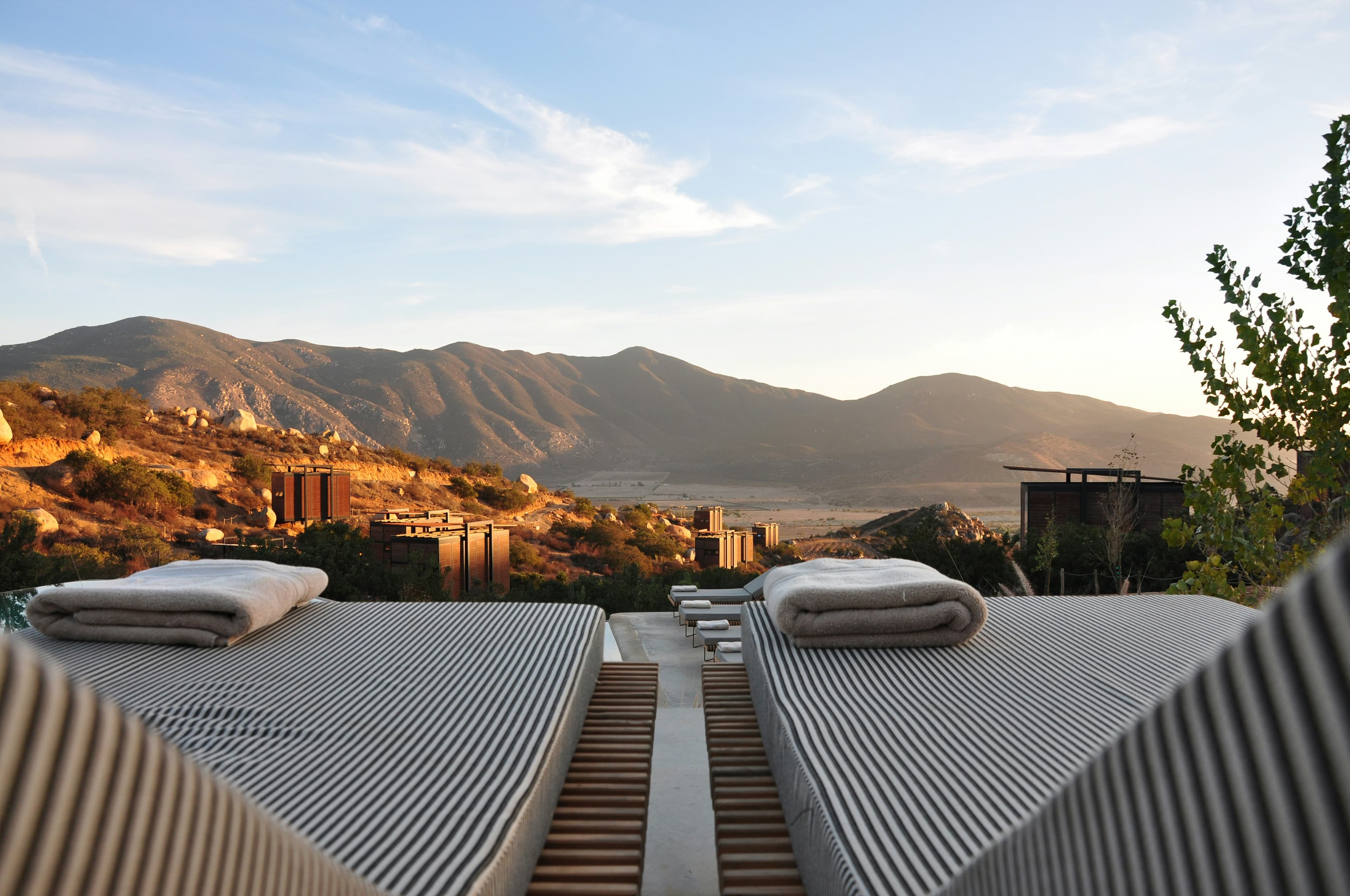 Daybeds on a terrace looking out to mountains