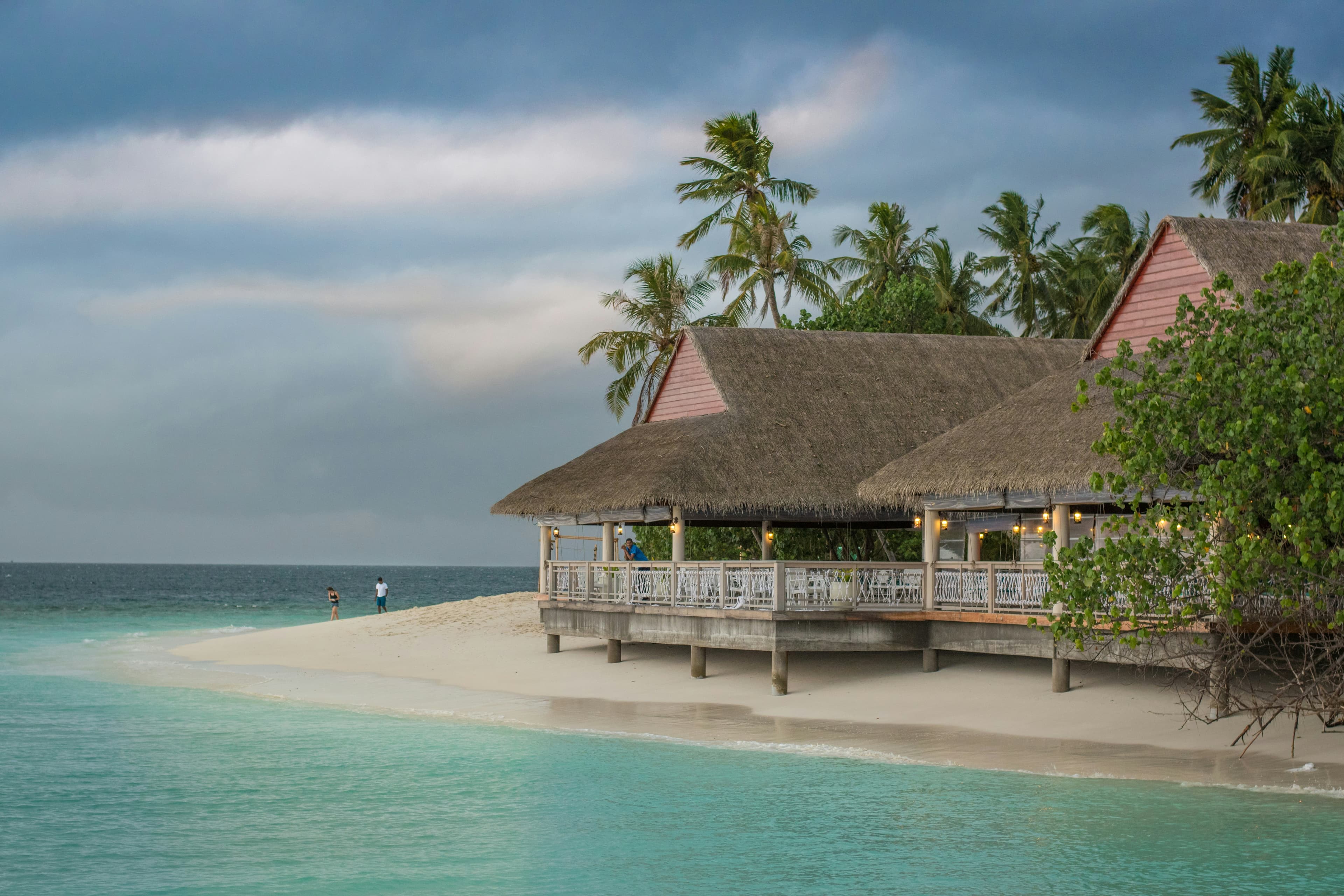 A thatched bungalow on a quiet tropical beach