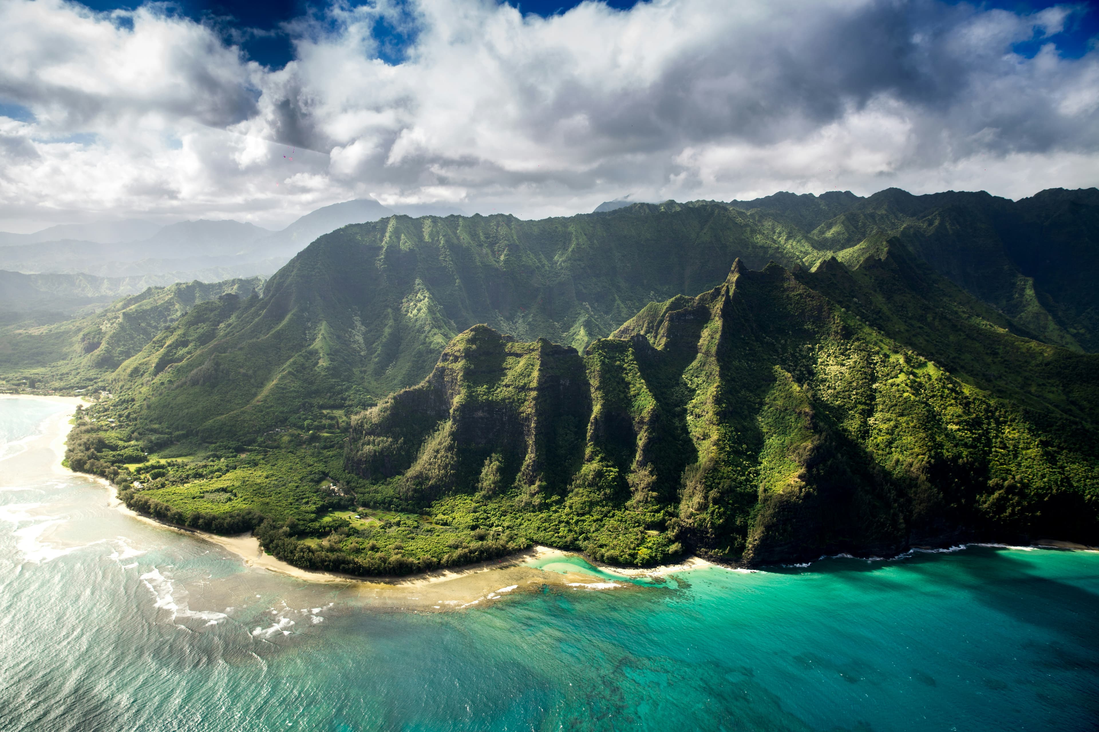 Green ridges of the Na Pali coast falling into the Pacific