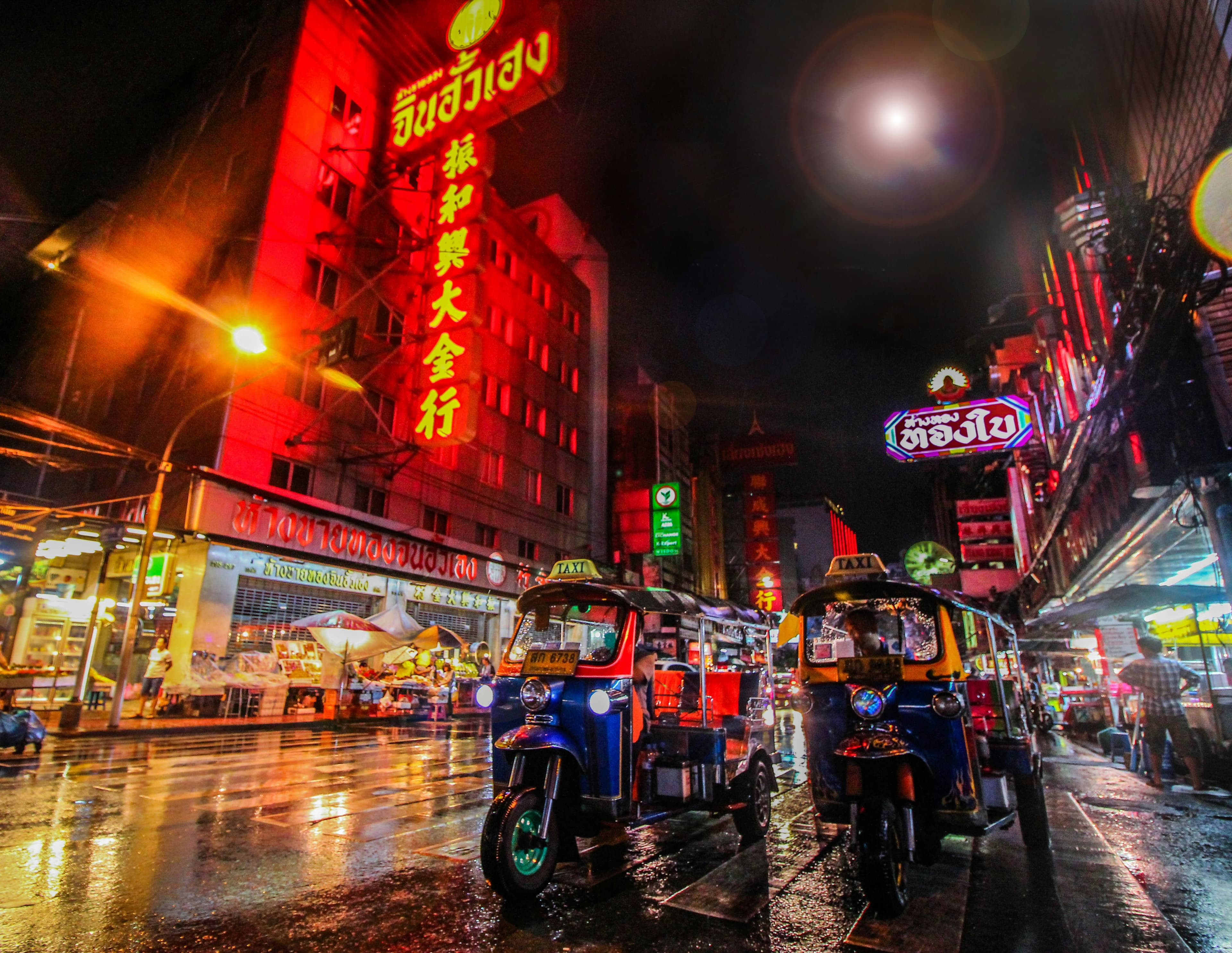 Neon signs and tuk-tuks in Bangkok’s Chinatown at night