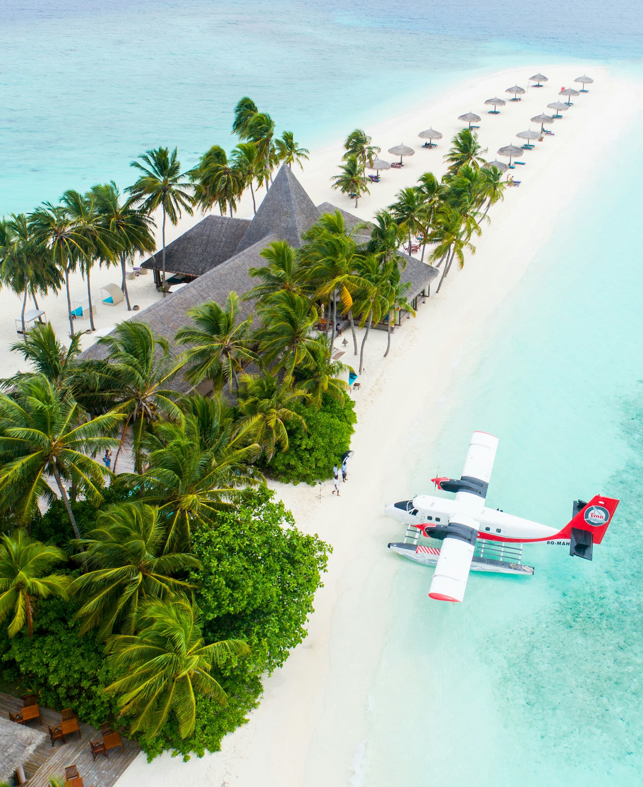 A seaplane moored beside a palm-lined Maldives island