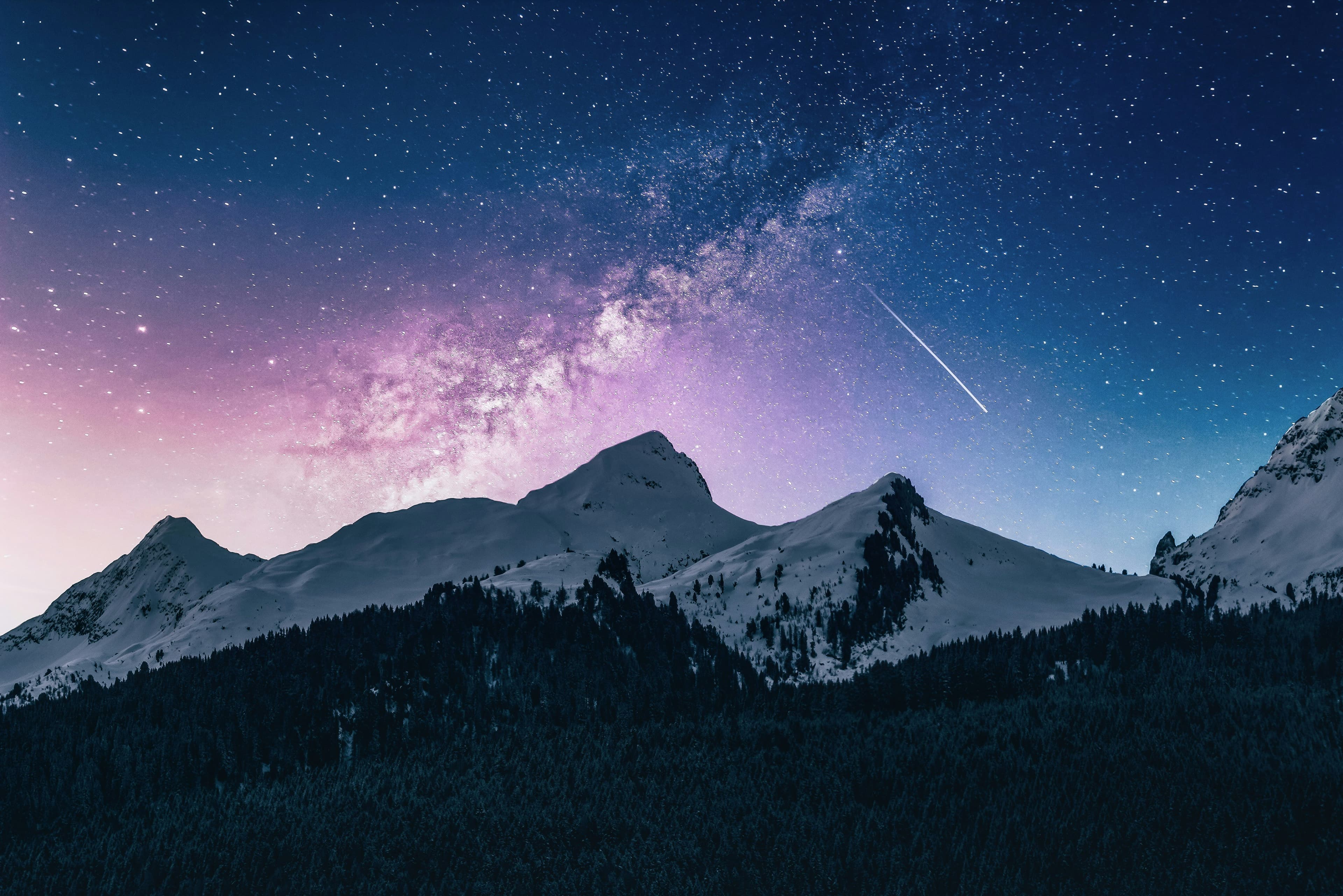 Snowy mountains under a starry sky