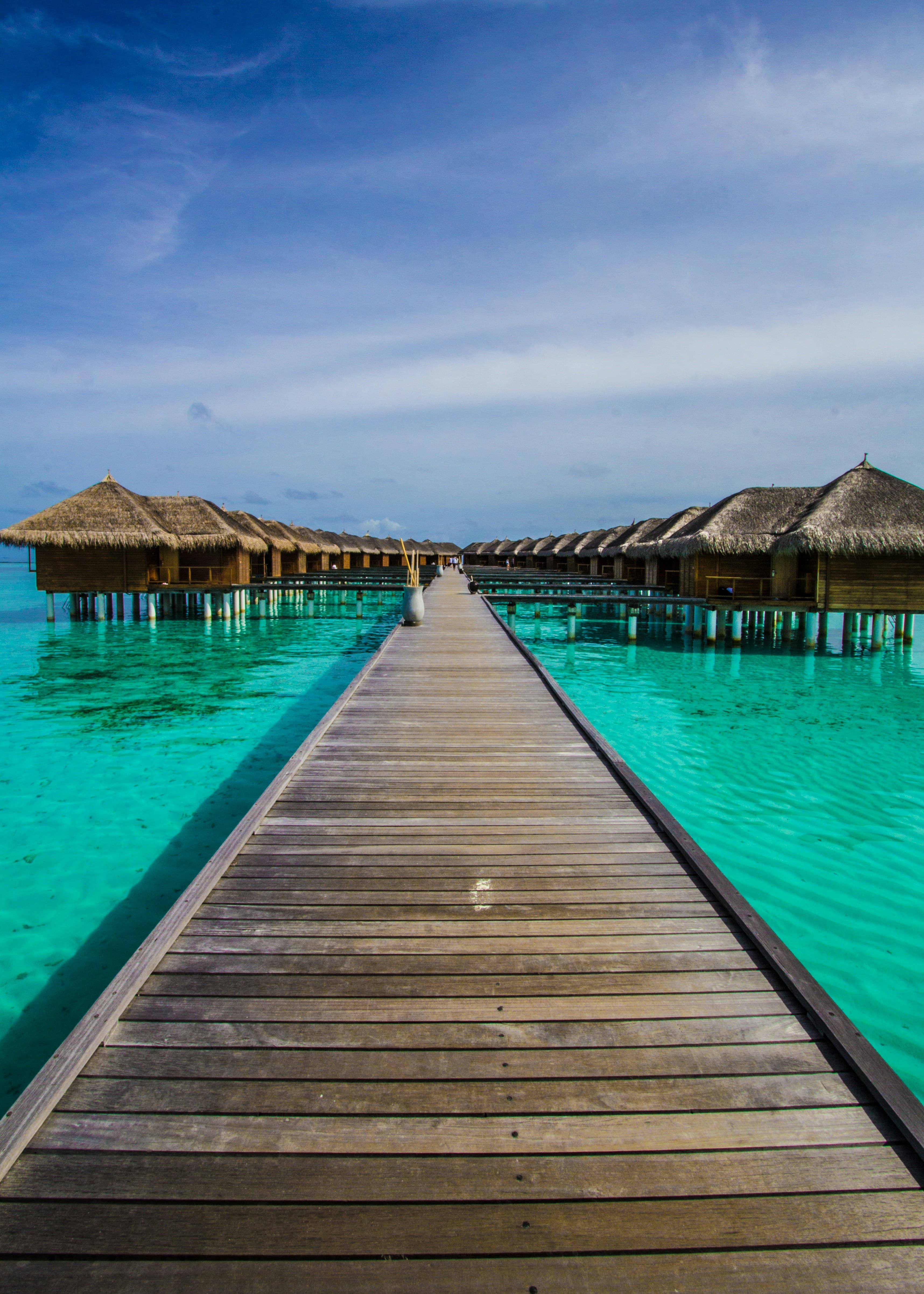 A wooden jetty leading to overwater villas