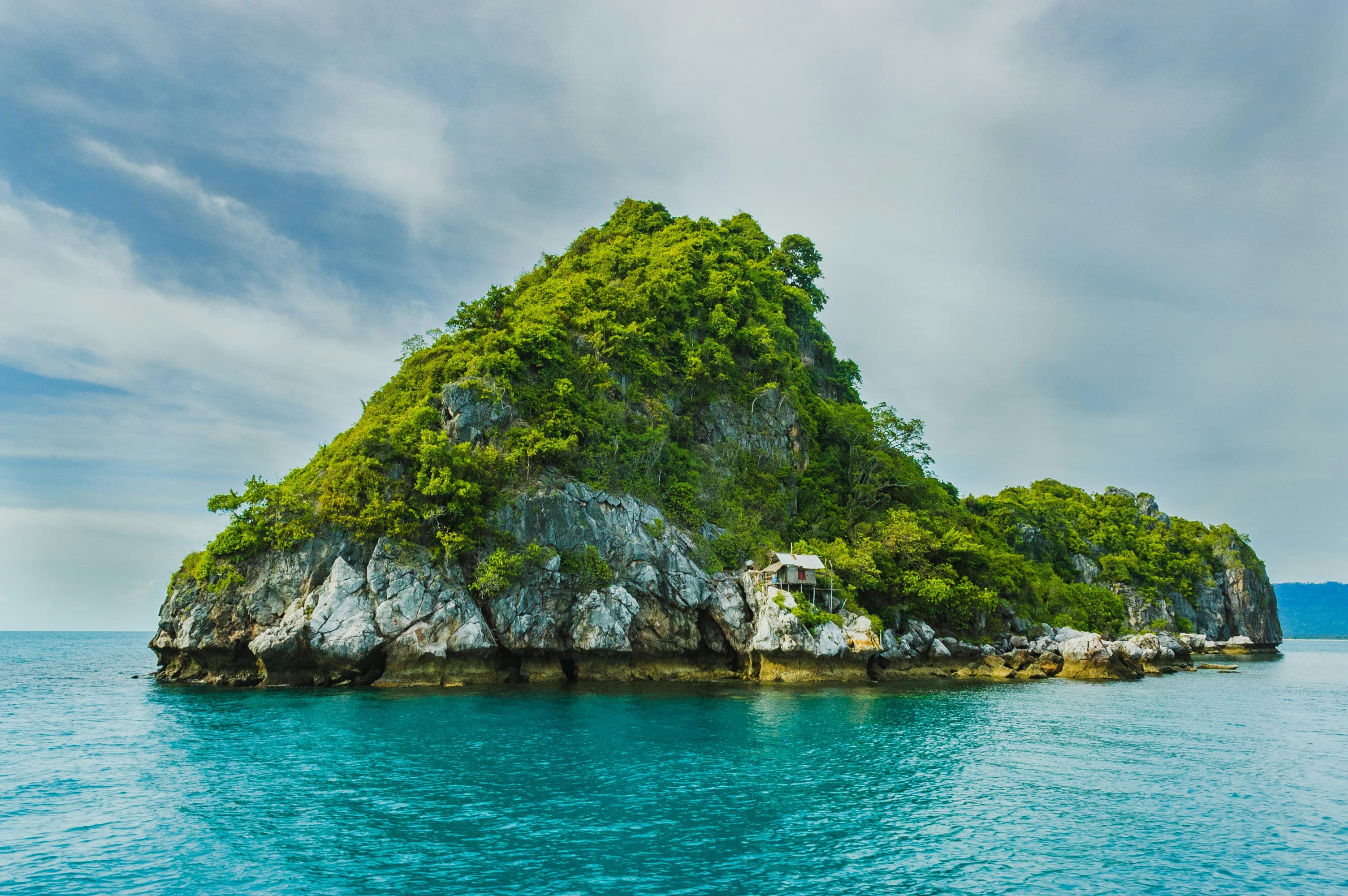 A small green island in turquoise water