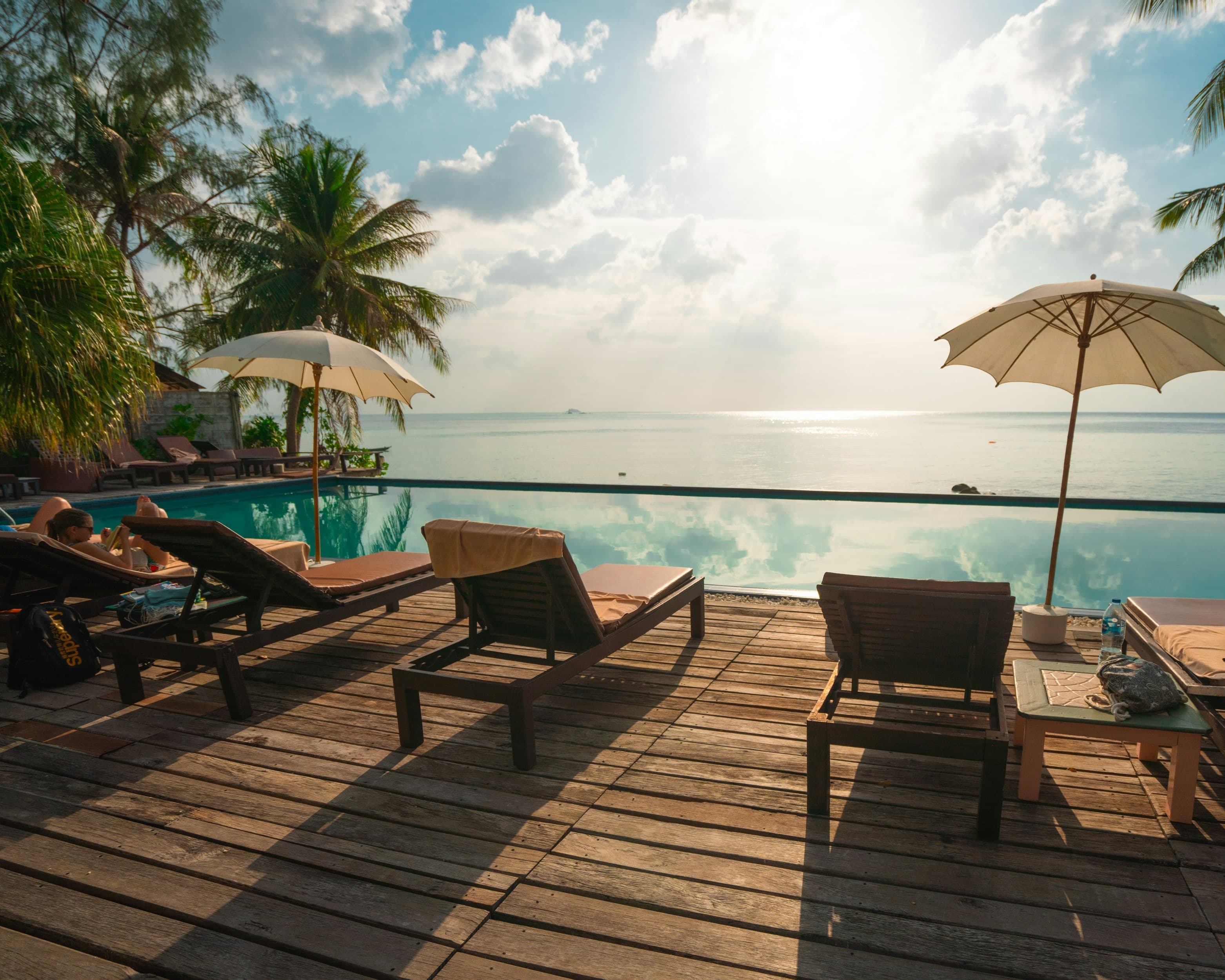 An infinity pool deck looking out over the sea