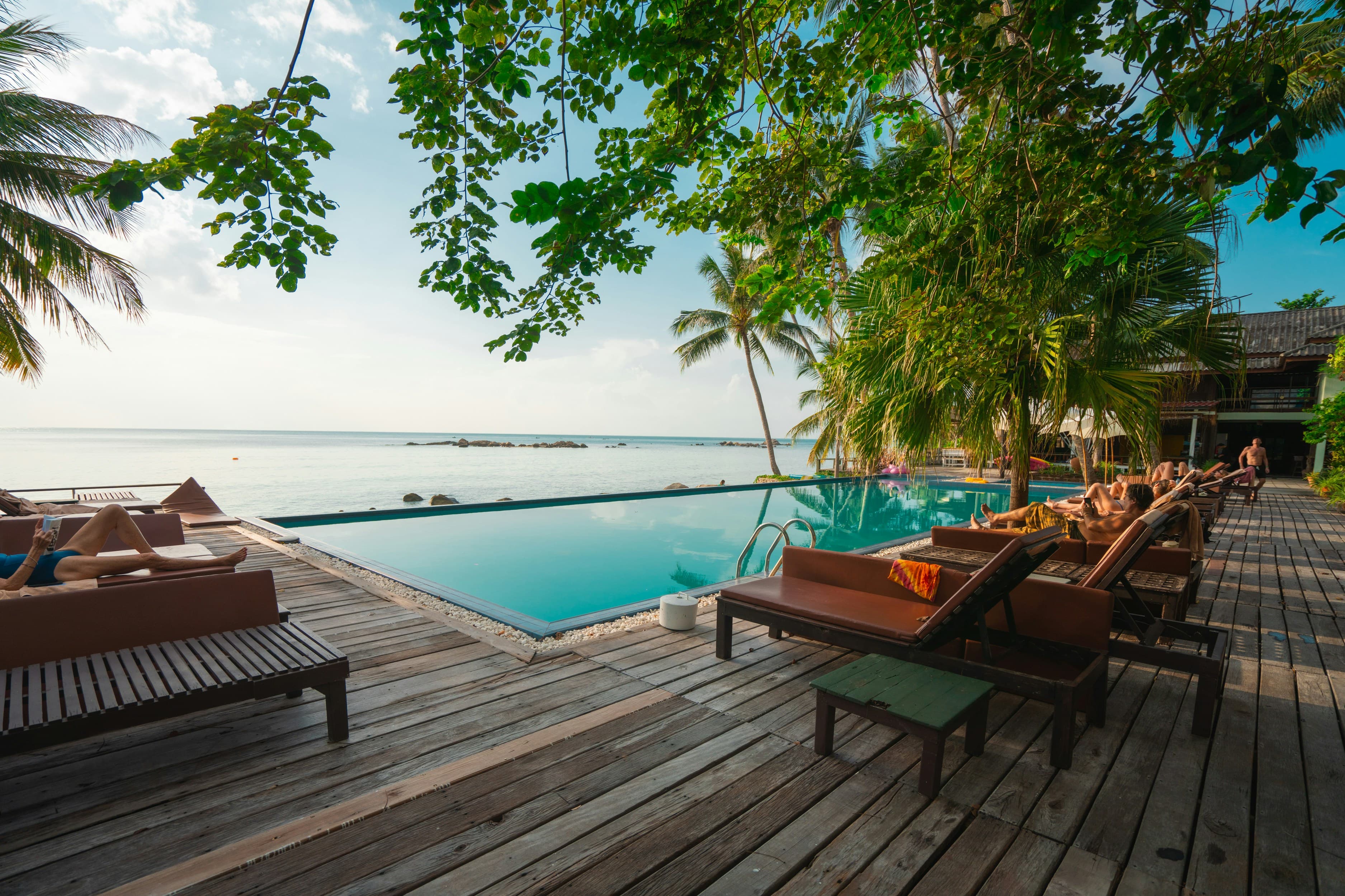 An infinity pool surrounded by tropical trees