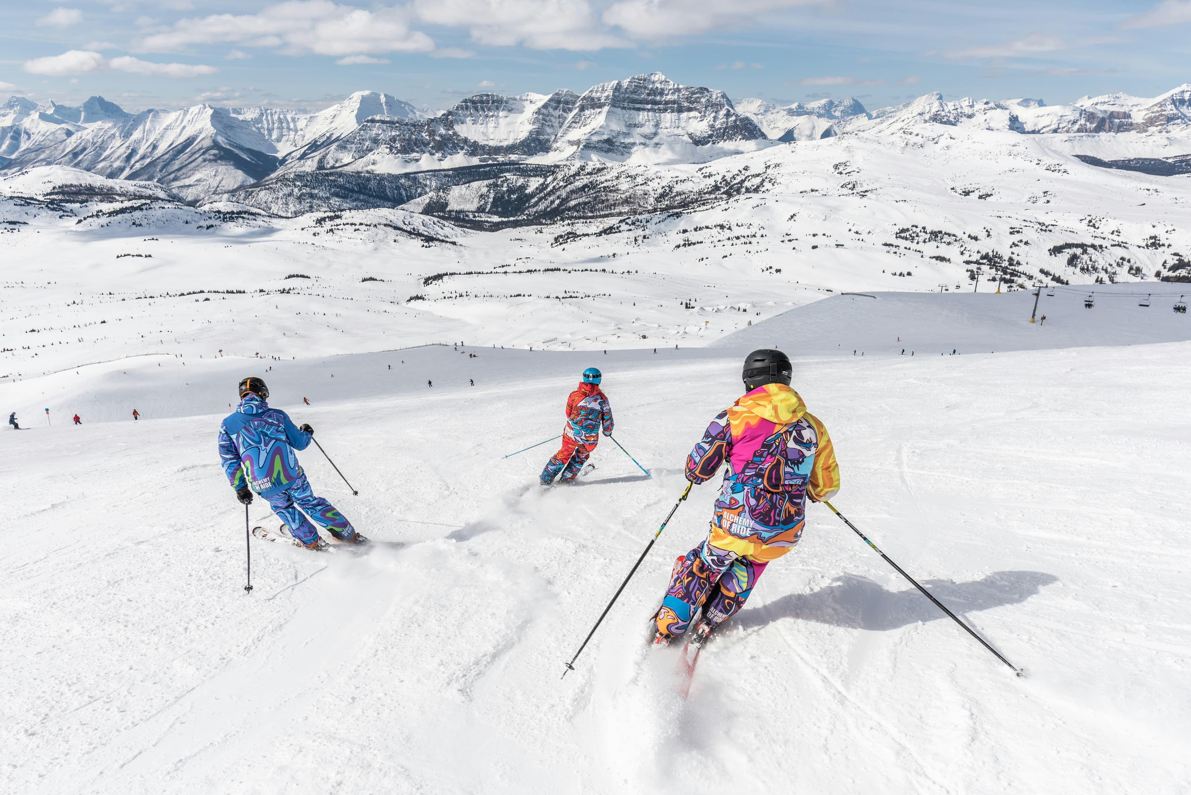 Skiers on a sunny alpine piste
