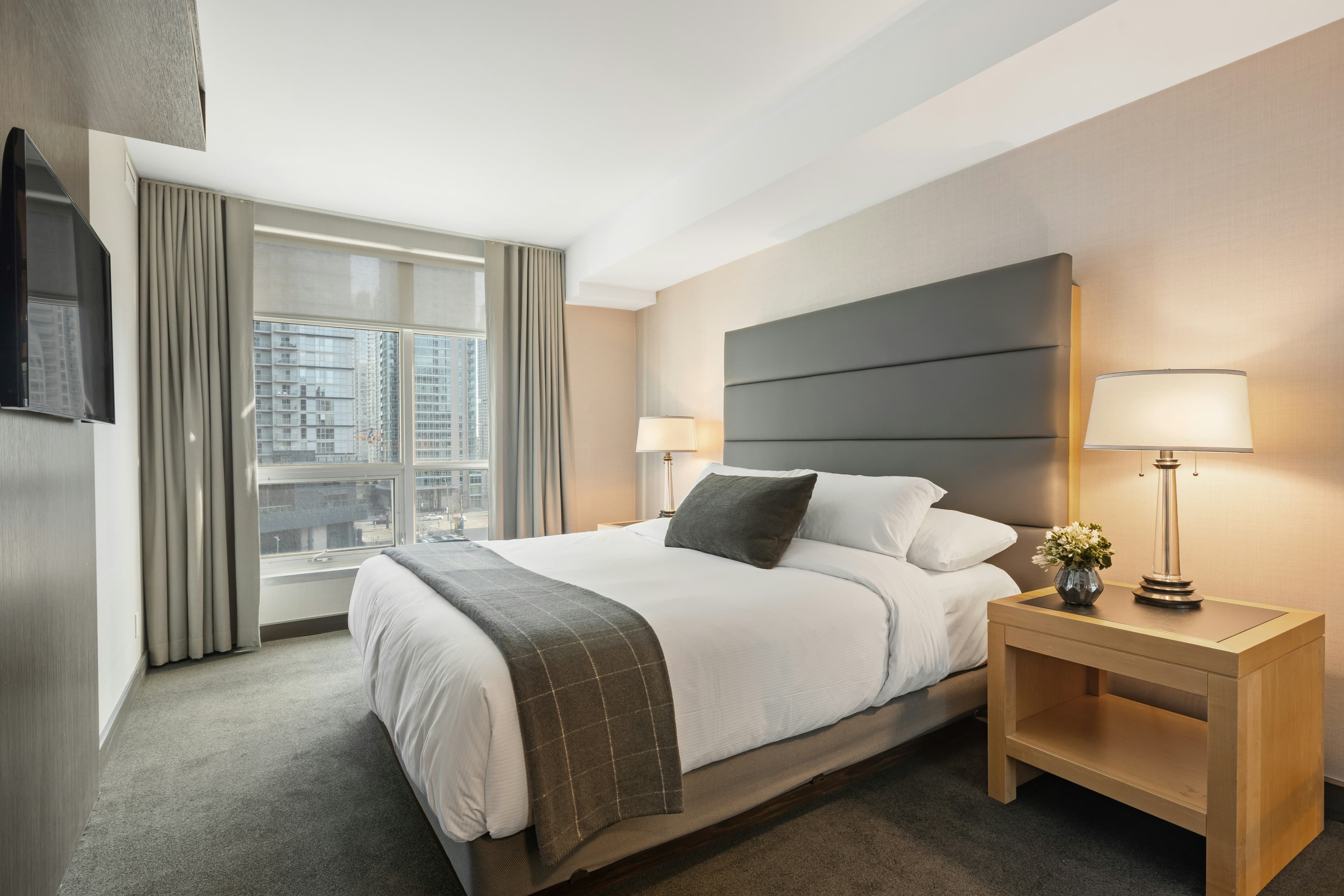 A calm, gray-toned hotel room